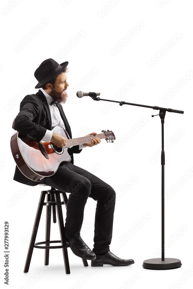 Wall mural guy singing on a microphone and playing an acoustic guitar