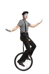 Mime riding a unicycle and making a grimace