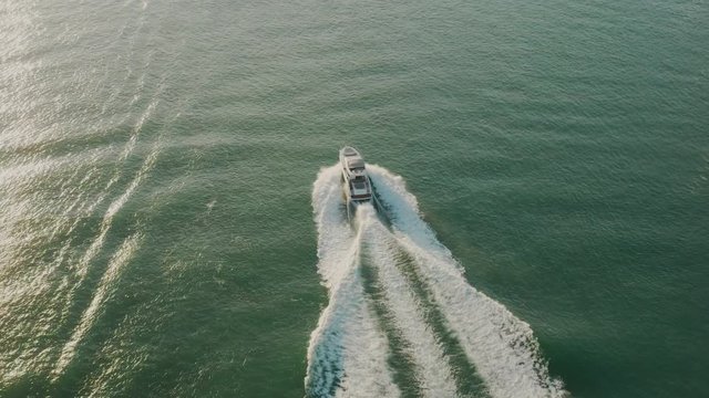 Aerial view of a boat sailing across the ocean