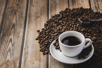 cup of coffee and beans on wooden table