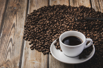 cup of coffee and beans on wooden table