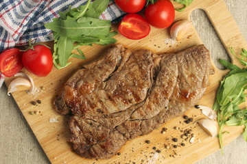 A beef steak well done with vegetables