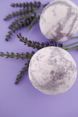 Lavender Bath Bomb. Purple striped  bath bombs set and sprigs of lavender close-up on a lilac background. body cosmetics	
