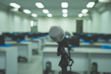 Microphone on abstract blurred of speech in computer room