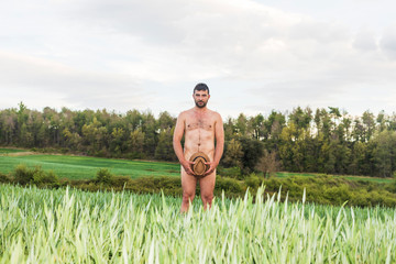 Man covering himself with summer hat at countryside