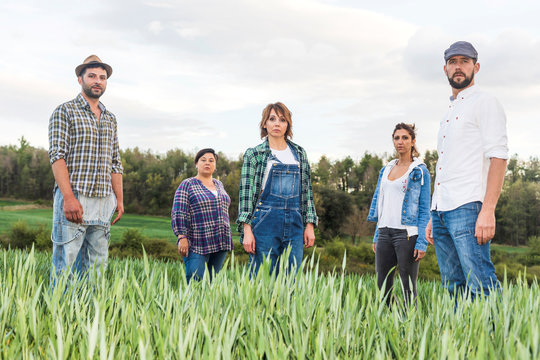 Group of rural people standing at countryside while looking camera