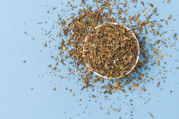Dried cistus on blue background. Top view
