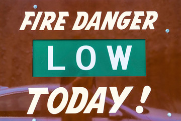 Close up view of a sign that reads Fire Danger Low Today