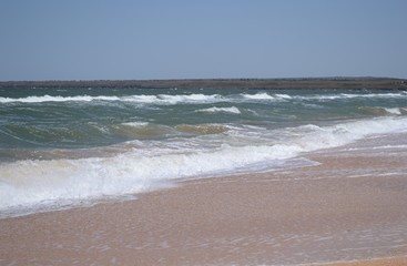 Fototapeta na wymiar Sea view with waves and sandy beach.