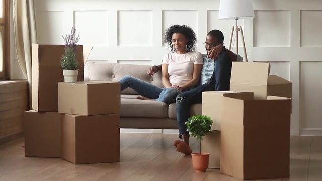 Happy african american family with kids on moving day concept