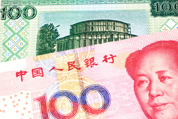 A close up image of a one hundred yuan note from the People's Republic of China with a one hundred ruble note from Belarus