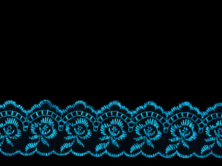 Blue laces on black background. Concept sewing still life