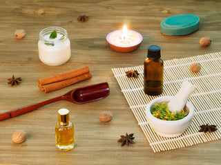 Fototapeta na wymiar Natural aromatherapy and spa ingredients on a brown wooden background with candle