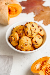 Pumpkin cookies with chocolate chips made from cake mix in a white ceramic bowl.