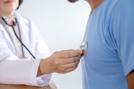 Asian female doctor checking patient heart rate in the hospital.