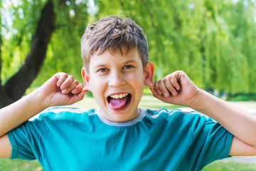 teenage boy fooling around. Shows tongue