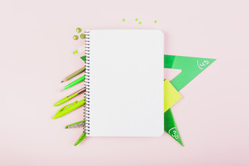 Green school stationery and copybook composition