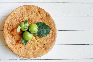 Tasty homemade apple pie on white wooden background with copy space