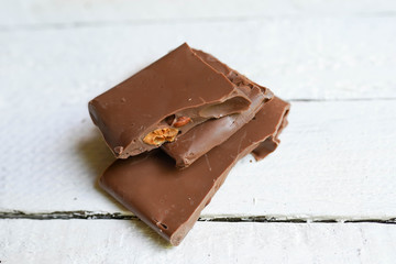 tasty chocolate on white wooden background