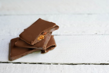 tasty chocolate on white wooden background with copy space