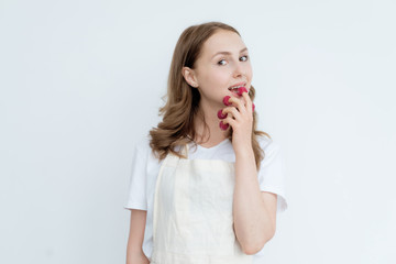 Beautiful girl holding raspberries on her fingers. Healthy eating, fruit diet, healthy lifestyle concept.