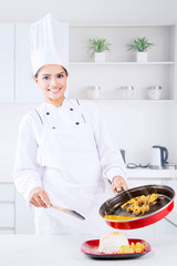 Indian female chef pours tripe soup into a plate