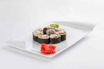 Roasted beef sushi roll with mayo on top isolated on white background