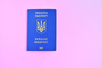 Biomedical Ukraine id passport on orange background with selective focus and empty space for photo or text. Ukrainian id passport with a golden symbol trident on brown backdrop. Copy space 