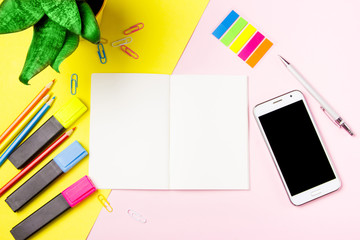 Front view colour pencils smartphone notepads on yellow background. Empty text important future...