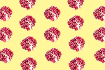Fruit pattern of Pomegranates on yellow background.