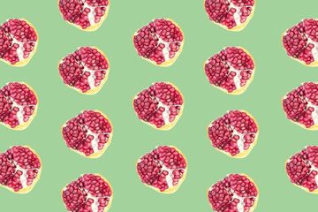 Fruit pattern of Pomegranates on green background.