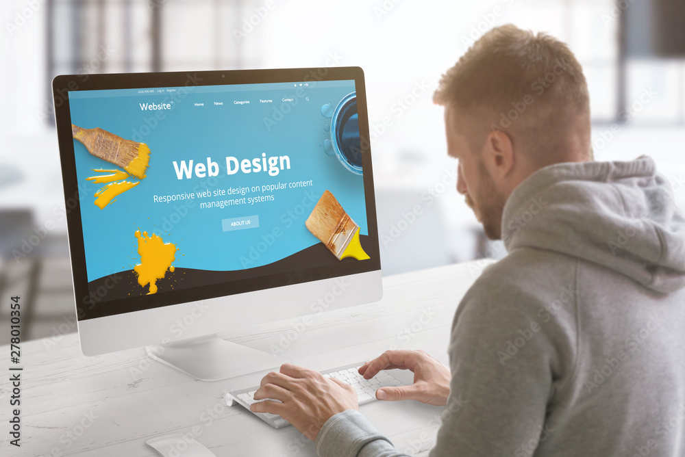 Leinwandbilder Guy work on modern web site on computer in graphic, web design studio office. Concept.