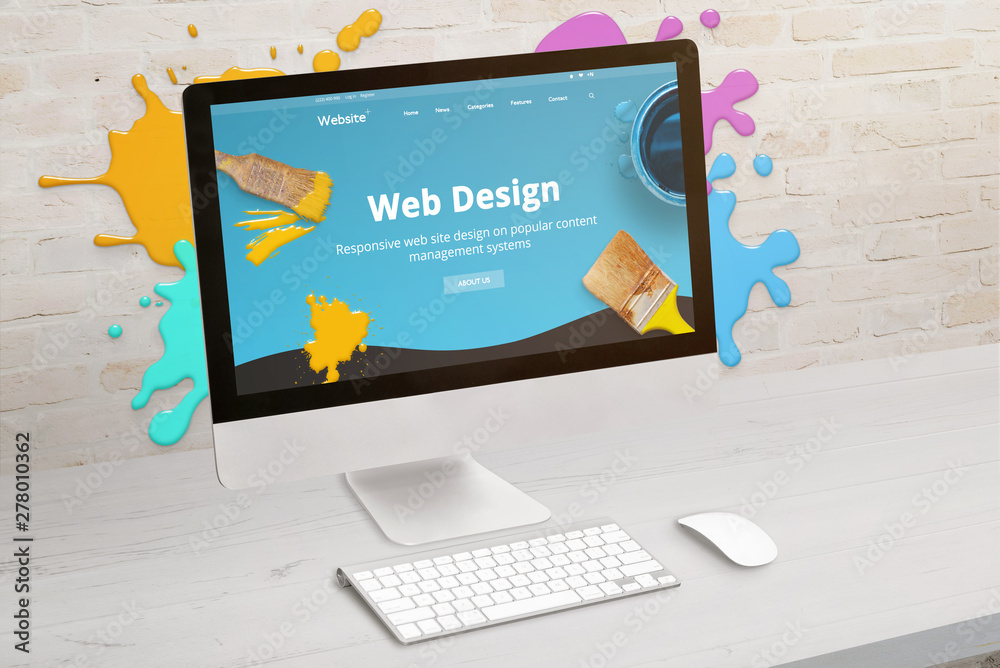 Wall mural Concept of web design studio with coimputer display and color drops on brick wall. Modern web design teme on screen. Concept of modern graphic studio desk.