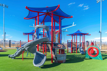 Colorful playground for children on a grassy terrain viewed on a sunny day