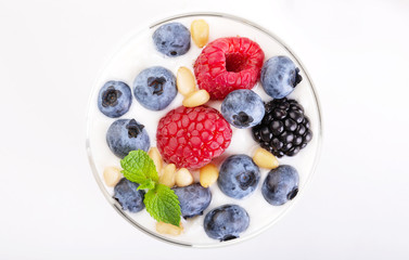 Two glasses of white yogurt with wild berries