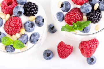 Two glasses of white yogurt with wild berries