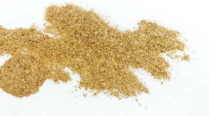 Golden glitter sparkle texture on white background.