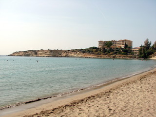 Unpopulated city beach early in the morning draws its coolness and gentle, warm sea water.