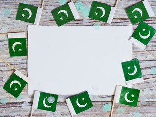 independence day of Pakistan. August 14. the concept of freedom, independence and patriotism. flags and confetti with sheets of white paper on a wooden background