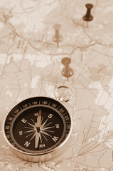 Fototapeta na wymiar Compass on map with push pins