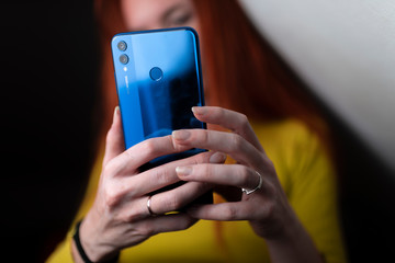 the girl uses a modern blue phone