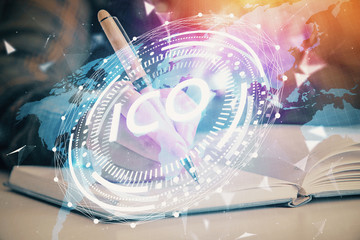 Cryptocurrency hologram over woman's hands writing background. Concept of blockchain. Double...