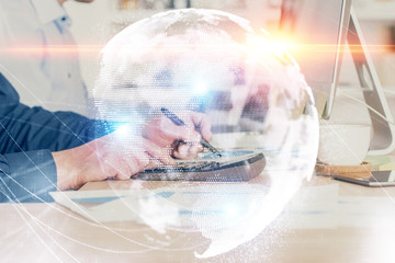 Double exposure of businessman working on laptop on background. International business hologram in front. Concept of success.