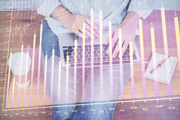 Forex graph with businessman working on computer in office on background. Concept of hardworking. Closeup. Multi exposure.