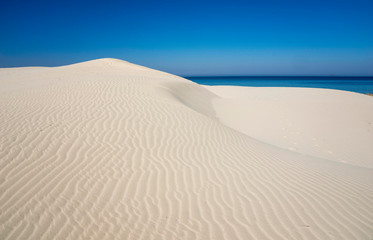 Fototapeta na wymiar white dunes of Is Arenas and blue sea in Sardinia
