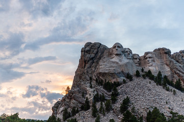 A dramatically colorful sky developing around sunset behind the four US presidents of Mount...