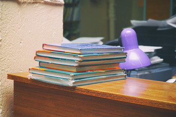 Old books in a stack on a wooden table