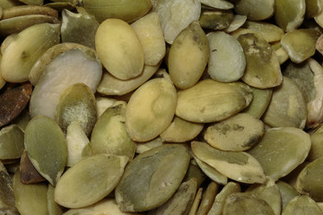 Vegan food. Raw pumpkin seeds for roasting closeup.