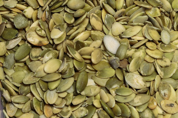Vegan food. Raw pumpkin seeds for roasting closeup.