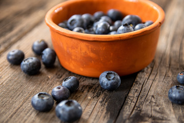 Fresh raw organic blueberries on vintage wooden table